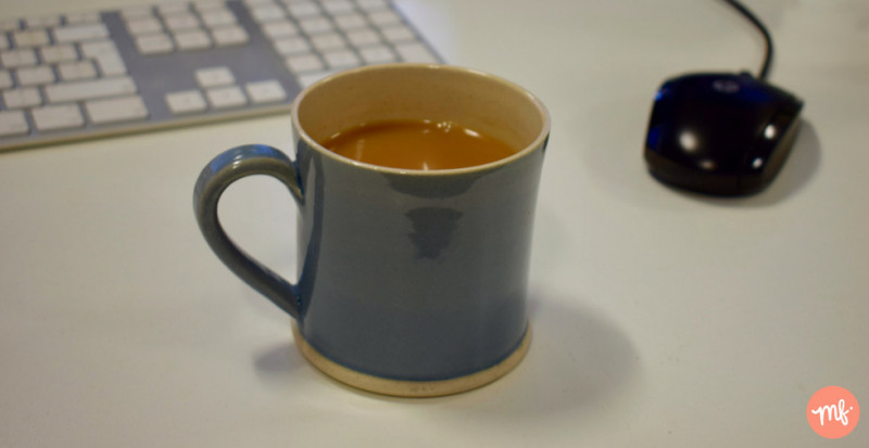 Blue mug of tea on a desk