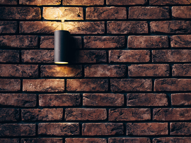 Brown bricked wall with light fitting on