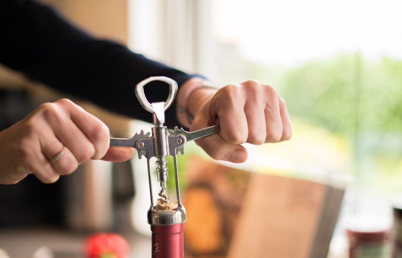 Close up of corkscrew removing a cork from a wine bottle