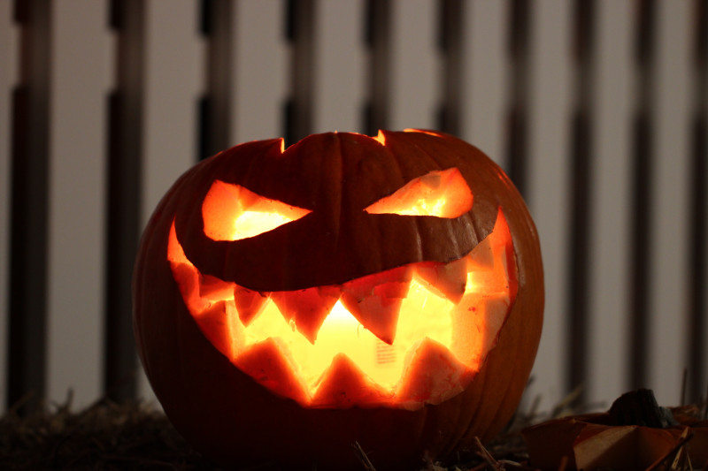 Close up of a lit up carved Halloween pumpkin