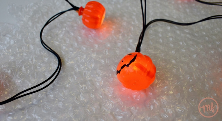 Close of up bubble wrap and an illuminated pumpkin fairy light