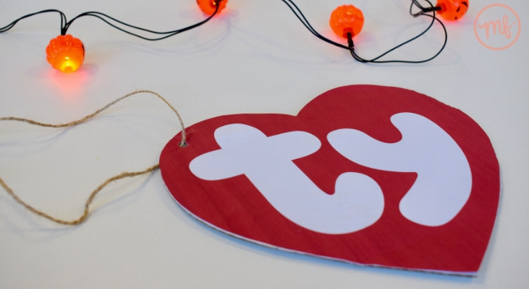 Carboard TY tag against a white background with pumpkin fairy lights
