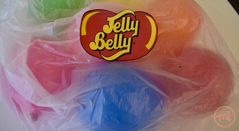 Clear plastic bin bag filled with coloured balloons