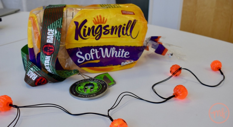 Medal and loaf of Kingsmill bread on a white table with pumpkin fairy lights around